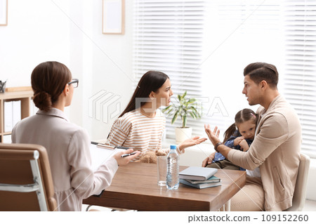 Professional psychologist working with family in office 109152260