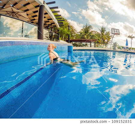 Embracing aquatic fitness, a pregnant woman demonstrates strength and serenity in underwater aerobics, creating a serene and empowering image in the pool Embracing aquatic fitness, a pregnant woman demonstrates strength and serenity in underwater aerobics, creating a serene and empowering image in the pool 109152831