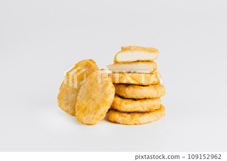 Chicken Breaded Fillet. Breaded chicken nuggets. Fast homemade food at home. Chicken breaded schnitzels. Breaded Chicken Inner Fillet on a White Background,Chicken Breaded Raw Meat. Fast cooking. 109152962