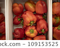 Red pepper in a box. Peppers on the market. Fresh vegetables. 109153525
