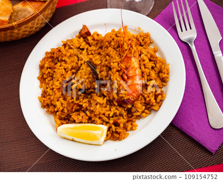 Paella with seafood served in a plate 109154752
