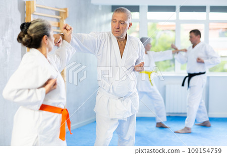Senior karate practitioner engage in fierce fight oriental single combat Senior karate practitioner engage in fierce fight oriental single combat 109154759