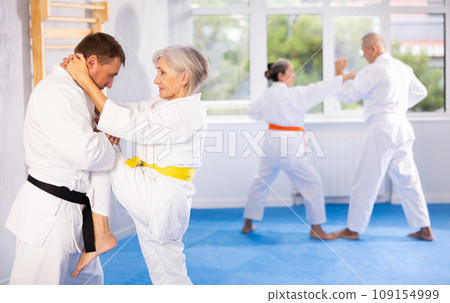 Senior judo practitioner engage in fierce fight 109154999