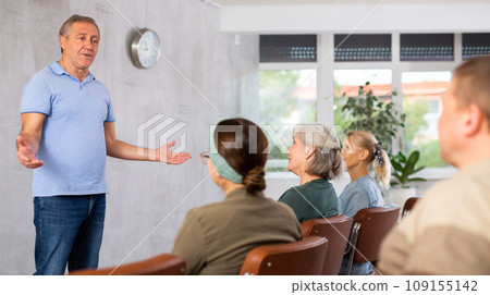 Older male teacher explaining subject to mature students Older male teacher explaining subject to mature students 109155142