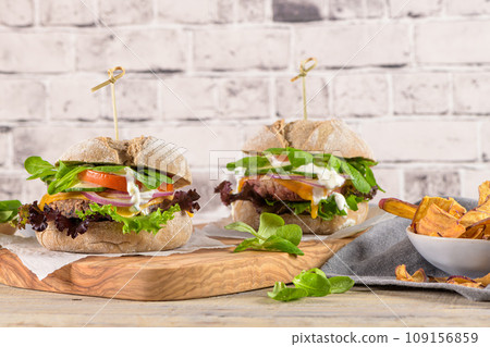 Healthy vegan burger with fresh vegetables and yogurt sauce Healthy vegan burger with fresh vegetables and yogurt sauce 109156859