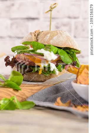 Healthy vegan burger with fresh vegetables and yogurt sauce Healthy vegan burger with fresh vegetables and yogurt sauce 109156879