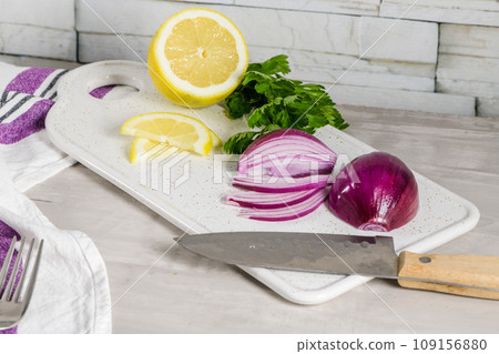 Sliced red onion, lemon and parsley leaves 109156880
