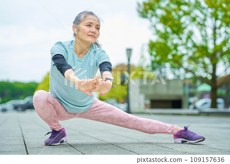 Senior woman exercising outdoors 109157636