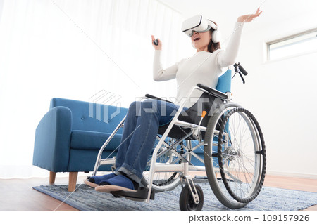 A woman in a wheelchair using a head-mounted display A woman in a wheelchair using a head-mounted display 109157926