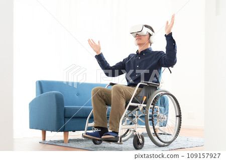 A man in a wheelchair using a head-mounted display A man in a wheelchair using a head-mounted display 109157927
