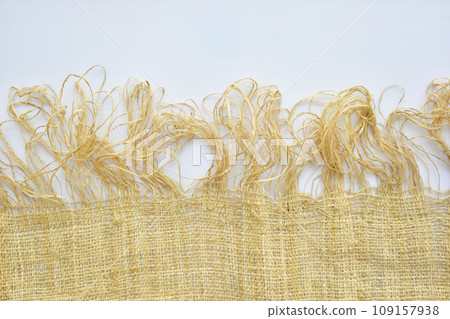 torn sackcloth isolated on white background, burlap fabric texture for design 109157938