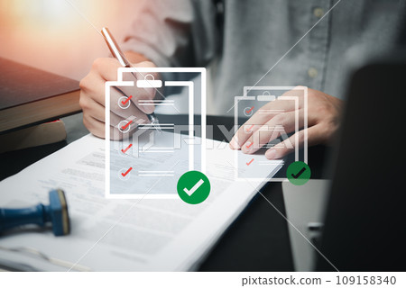 business management with document check list at work place. Man holding pen mark on checklist report virtual screen. business management with document check list at work place. Man holding pen mark on checklist report virtual screen. 109158340