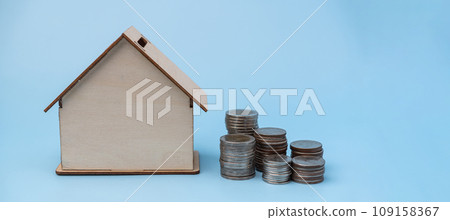 Stack coin and model home bank. Saving money for real estate concept. Business management financial home loans or money saving for house buying. 109158367