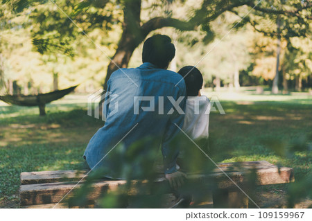 father and son in the park 109159967