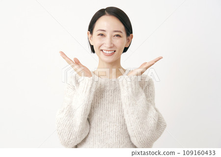 Middle-aged woman pointing left and right with the palm of her hand, white background Middle-aged woman pointing left and right with the palm of her hand, white background 109160433