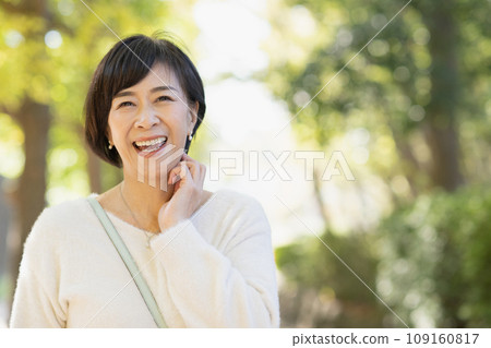 A woman in her 50s walking in the park A woman in her 50s walking in the park 109160817