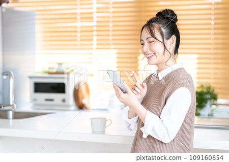 A young woman using a smartphone. A young woman using a smartphone. 109160854