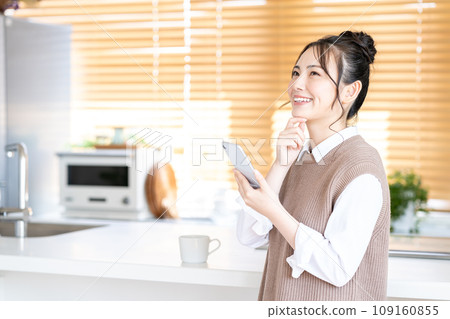 A young woman using a smartphone. A young woman using a smartphone. 109160855