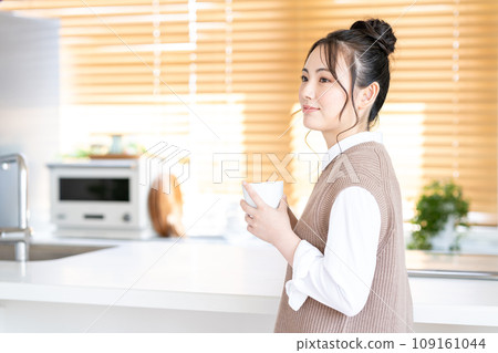 A young woman relaxing in the living room. A young woman relaxing in the living room. 109161044