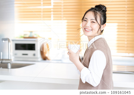 A young woman relaxing in the living room. A young woman relaxing in the living room. 109161045