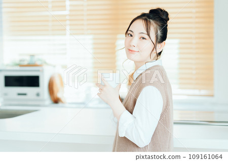 A young woman relaxing in the living room. A young woman relaxing in the living room. 109161064