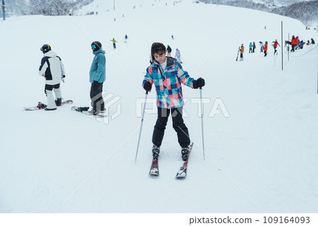 Young woman playing Ski in winter season. Snow winter activity concept Young woman playing Ski in winter season. Snow winter activity concept 109164093