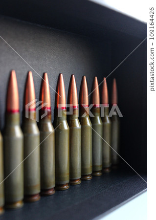 Vertical photo of live ammunition lined up stored in a black case Vertical photo of live ammunition lined up stored in a black case 109164426