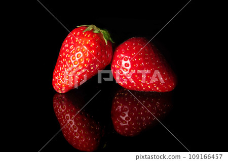 Ripe strawberry on a black background with reflection. 109166457