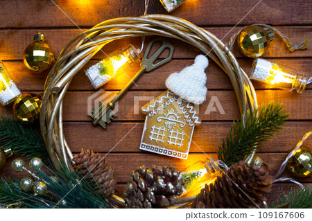 Key to house with a keychain tiny home on wooden background with Christmas decor layout. Gift for New Year, Christmas. Building, project, moving to new house, mortgage, rent and purchase real estate Key to house with a keychain tiny home on wooden background with Christmas decor layout. Gift for New Year, Christmas. Building, project, moving to new house, mortgage, rent and purchase real estate 109167606