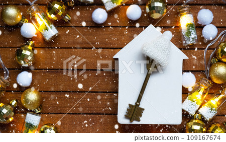 Key to house with a keychain tiny home on wooden background with Christmas decor layout. Gift for New Year, Christmas. Building, project, moving to new house, mortgage, rent and purchase real estate Key to house with a keychain tiny home on wooden background with Christmas decor layout. Gift for New Year, Christmas. Building, project, moving to new house, mortgage, rent and purchase real estate 109167674