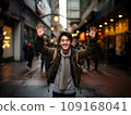 Smiling Japanese man raising his hands in joy 109168041