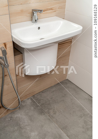 Wall mounted white porcelain sink with silver sensor faucet Wall mounted white porcelain sink with silver sensor faucet 109168129