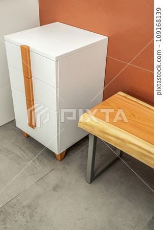 Live edge wooden bench with metal legs and white chest of drawers 109168139
