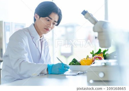 A young researcher observing the ingredients of vegetables under a microscope Registered dietitian 109168665