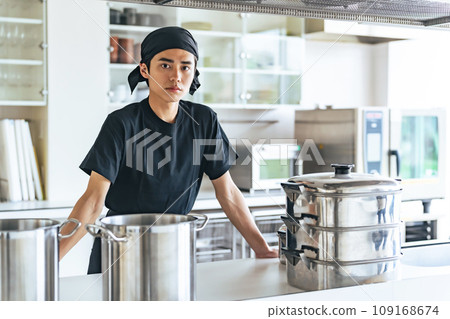 Male cook standing in the kitchen Male cook standing in the kitchen 109168674