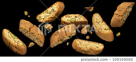 Falling Cantuccini cookies isolated on black background Falling Cantuccini cookies isolated on black background 109169088