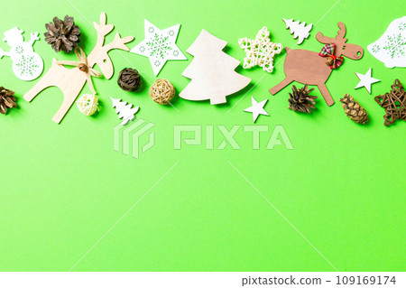 Christmas green background with holiday toys and decorations. Happy New Year concept with empty space for your design Christmas green background with holiday toys and decorations. Happy New Year concept with empty space for your design 109169174