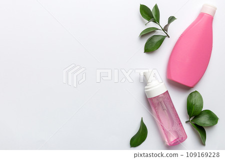 Organic cosmetic products with green leaves on white background. Copy space, flat lay 109169228