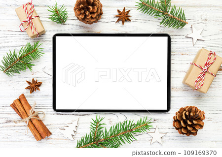 Digital tablet mock up with rustic Christmas wooden background decorations for app presentation. top view with copy space 109169370