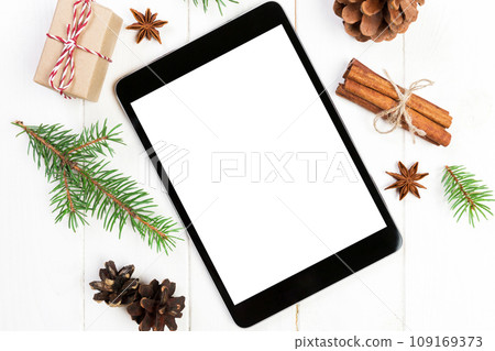 Digital tablet mock up with rustic Christmas wooden background decorations for app presentation. top view with copy space 109169373