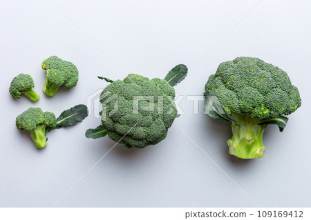 green fresh broccoli background close up on colored table. Vegetables for diet and healthy eating. Organic food 109169412