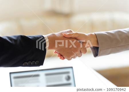 Business people shaking hands at a meeting 109170942