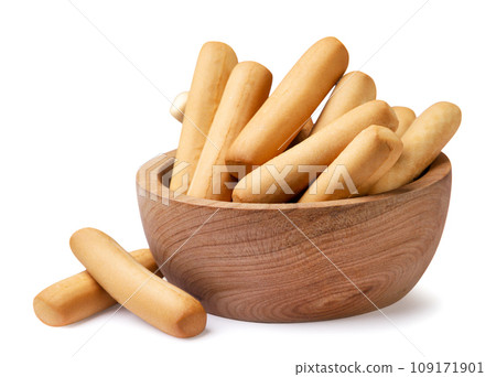 Grissini breadsticks in a wooden plate on a white background. Isolated Grissini breadsticks in a wooden plate on a white background. Isolated 109171901