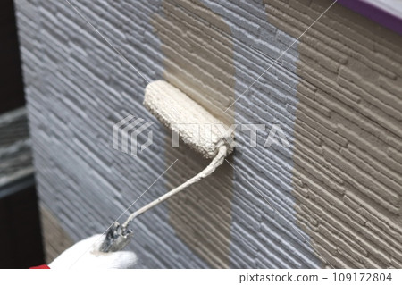 On-site girls apply intermediate coat to siding On-site girls apply intermediate coat to siding 109172804