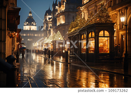 Winter cityscape featuring snow covered street of London with festive lights and decorations, a light snowfall, and holiday-themed street decor 109173262