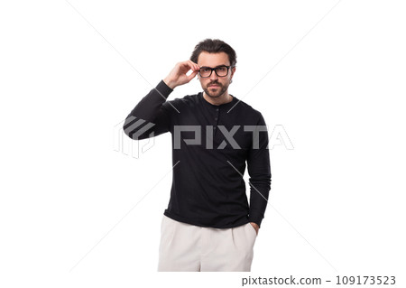 well-groomed young caucasian man with black hair and beard put on glasses for vision correction well-groomed young caucasian man with black hair and beard put on glasses for vision correction 109173523
