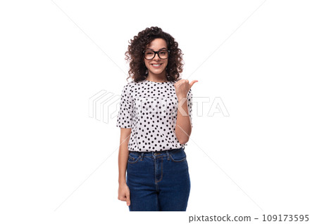 charming kind young brunette curly woman dressed in a summer blouse with a pea print actively 109173595