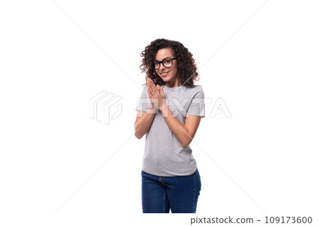 beautiful european woman with black curly hair wears eyeglasses on a white background with copy beautiful european woman with black curly hair wears eyeglasses on a white background with copy 109173600