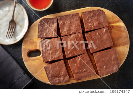 Chocolate brownie, simple coffee cake, overhead flat lay view on black 109174347