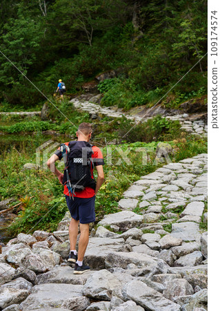 Man hiking in forest with backpack 109174574